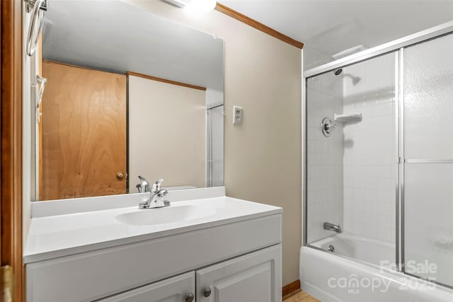 bathroom featuring vanity and bath / shower combo with glass door