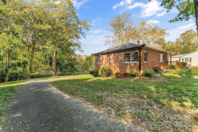 view of property exterior with a lawn