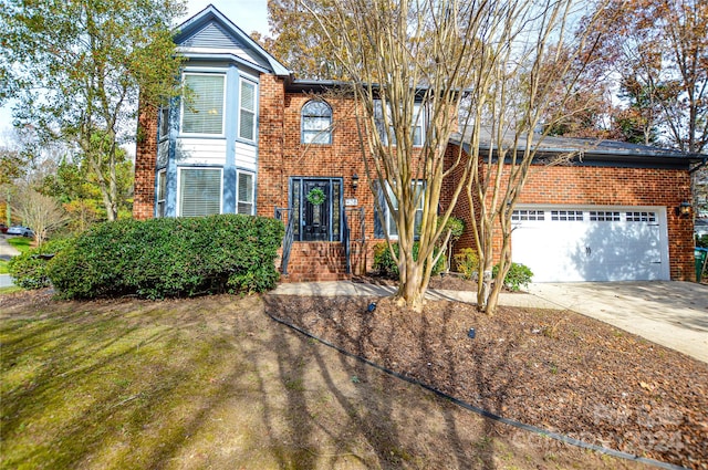 view of front of house featuring a front yard and a garage