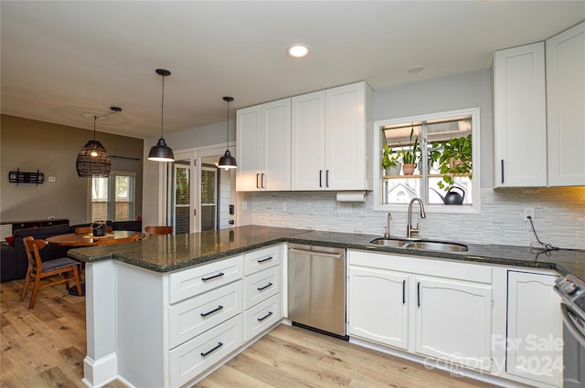 kitchen featuring appliances with stainless steel finishes, light wood-type flooring, white cabinetry, and a healthy amount of sunlight