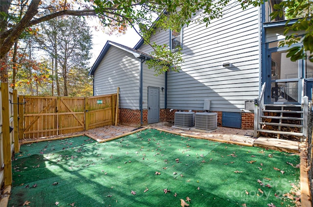 view of yard featuring central air condition unit