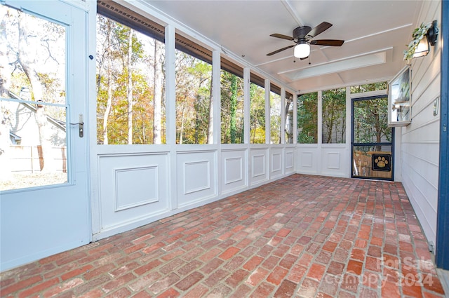 unfurnished sunroom with ceiling fan and a healthy amount of sunlight