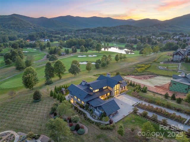 aerial view at dusk with a water and mountain view