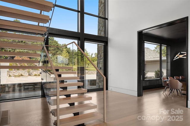 interior space featuring a high ceiling and plenty of natural light