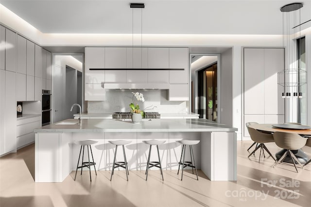 kitchen with sink, pendant lighting, a breakfast bar, and gray cabinetry