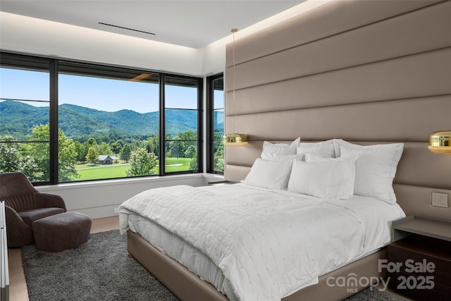 bedroom featuring a mountain view