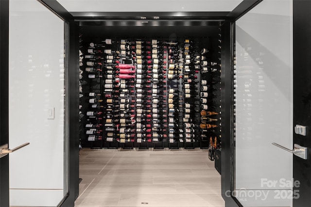 wine cellar featuring light wood-type flooring and electric panel