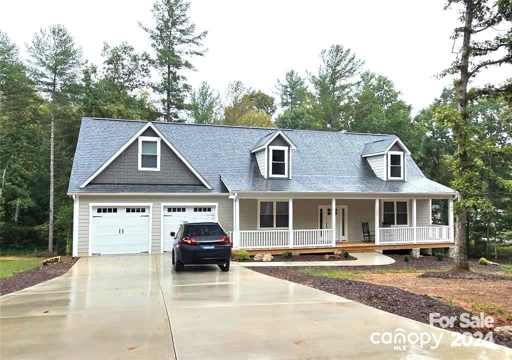 view of front of house with a porch and a garage