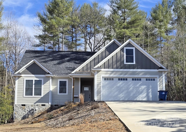 craftsman house featuring board and batten siding, crawl space, driveway, and a garage