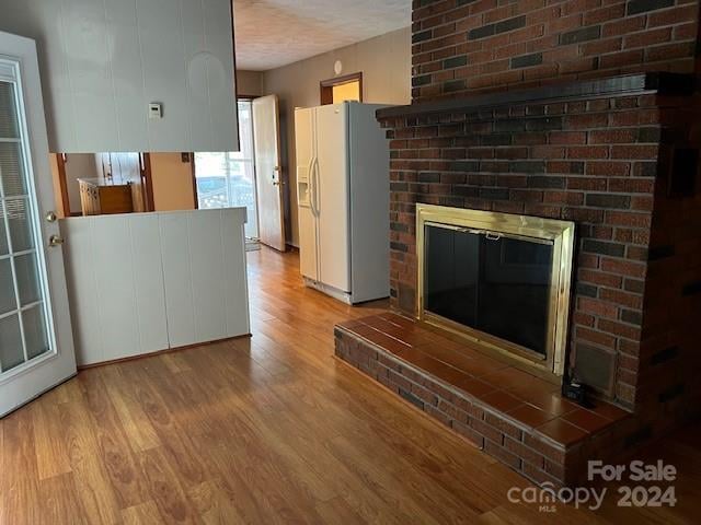 unfurnished living room featuring light hardwood / wood-style floors and a fireplace