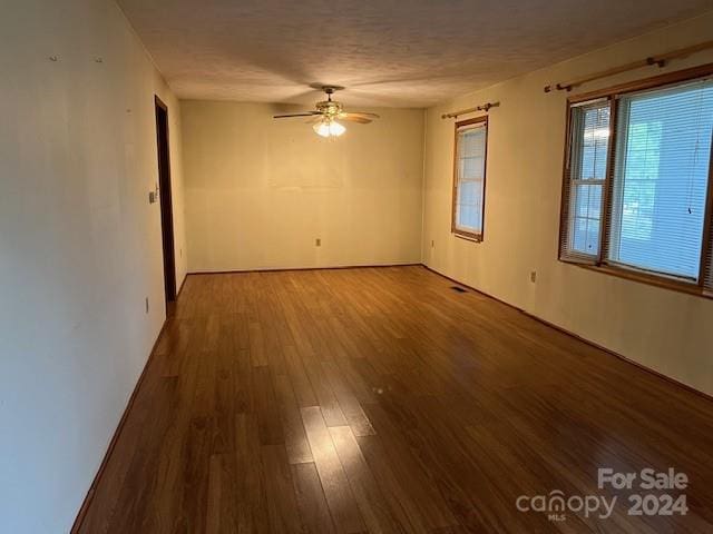 spare room featuring ceiling fan and hardwood / wood-style floors