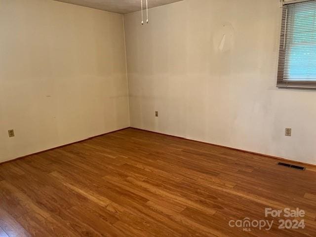 spare room featuring hardwood / wood-style floors