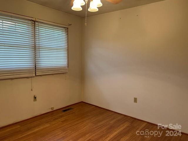 spare room featuring wood-type flooring