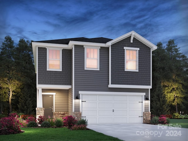 view of front of home featuring a garage and a front lawn