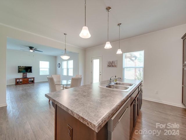 kitchen featuring a kitchen island with sink, sink, ceiling fan, and a wealth of natural light