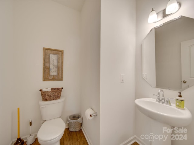 bathroom with wood-type flooring and toilet