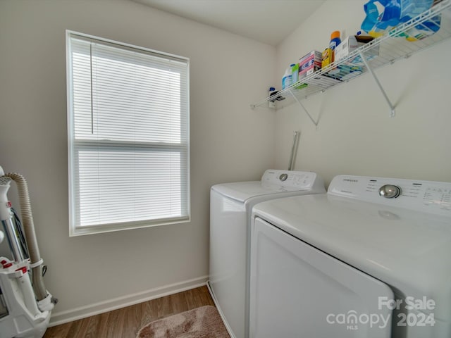 washroom with wood-type flooring and independent washer and dryer