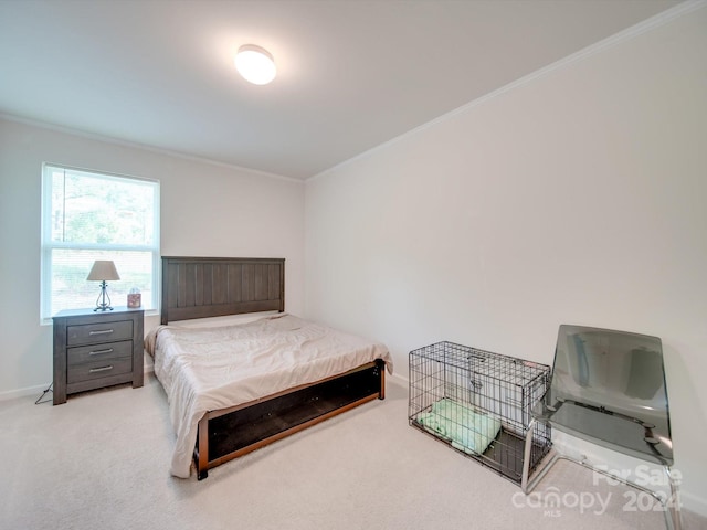 bedroom featuring ornamental molding and light colored carpet