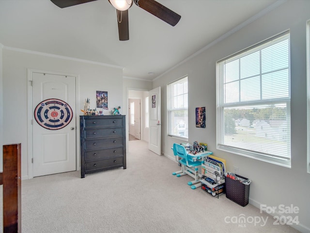 rec room with ceiling fan, light colored carpet, and ornamental molding