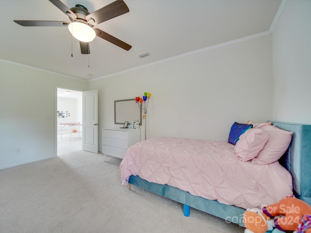 bedroom featuring ceiling fan, crown molding, and carpet flooring