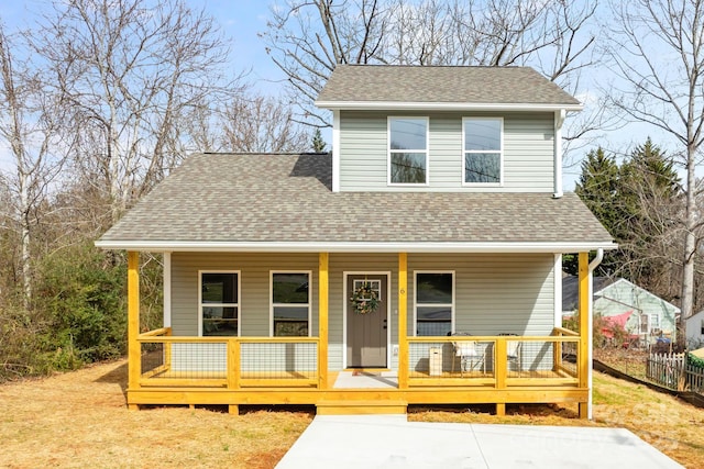 view of front of property featuring covered porch and a shingled roof