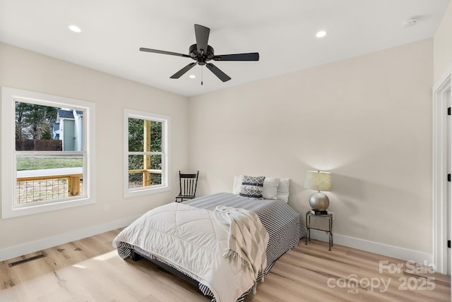 bedroom with light wood finished floors, baseboards, visible vents, a ceiling fan, and recessed lighting