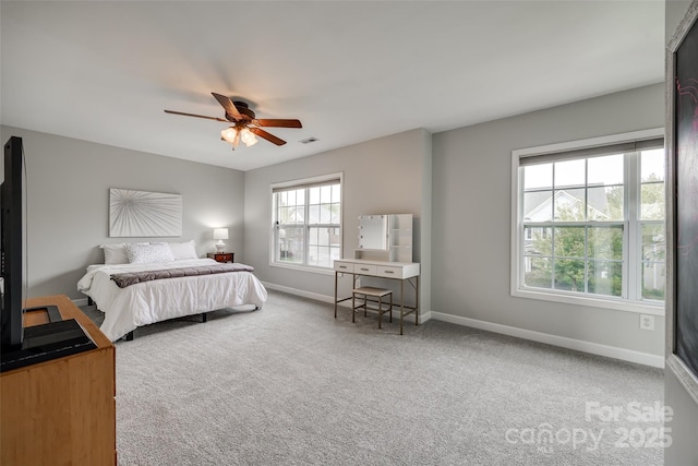 bedroom with carpet floors, visible vents, baseboards, and a ceiling fan