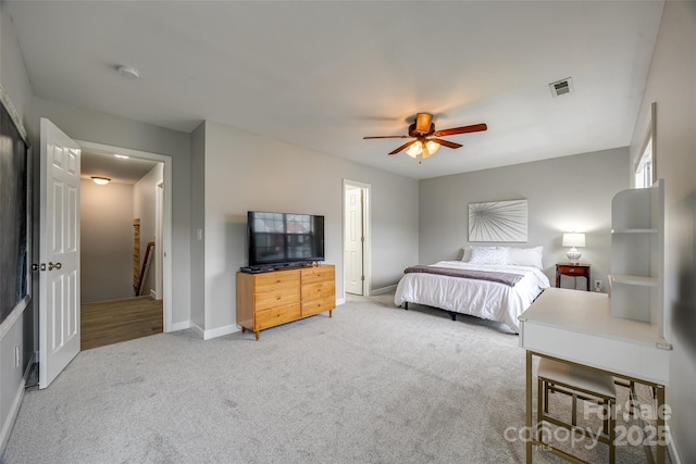 bedroom featuring carpet floors, baseboards, visible vents, and ceiling fan