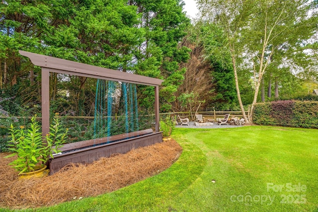 view of yard with an outdoor fire pit and a garden