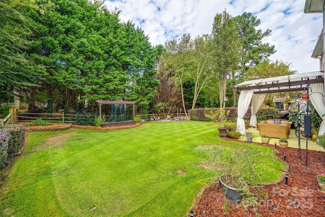 view of yard featuring a patio area, fence, and a pergola