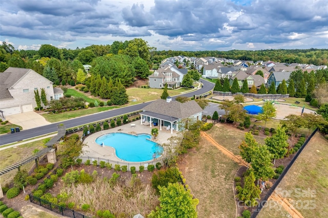 pool with fence and a residential view