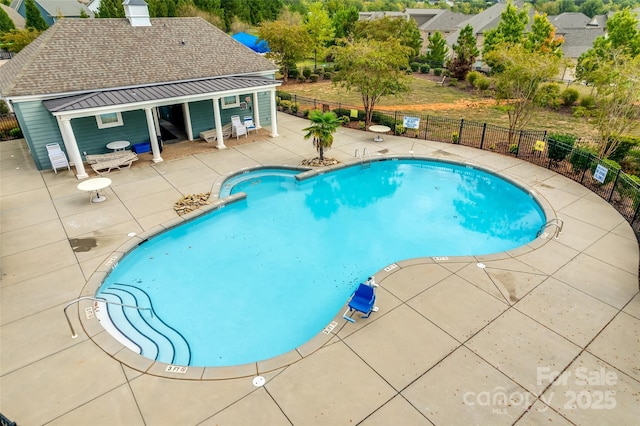 pool featuring a patio and fence