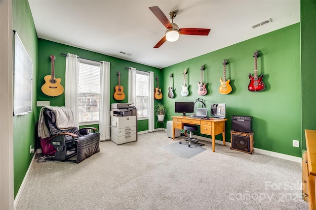 carpeted office featuring visible vents, baseboards, and a ceiling fan