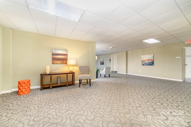 interior space featuring a drop ceiling and light colored carpet