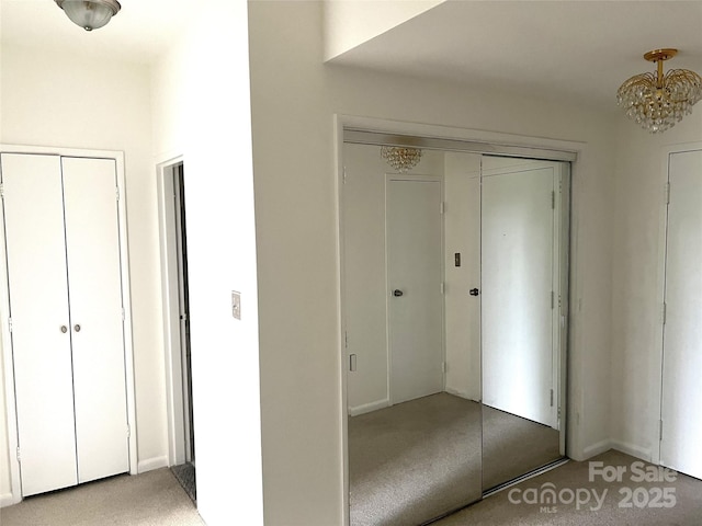 1300 Reece Rd Unit 302, Charlotte, NC 28209 - unfurnished bedroom featuring light carpet and a chandelier
