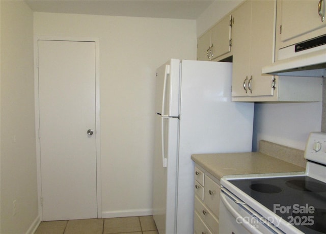 1300 Reece Rd Unit 302, Charlotte, NC 28209 - kitchen featuring electric range, light countertops, ventilation hood, and light tile patterned floors
