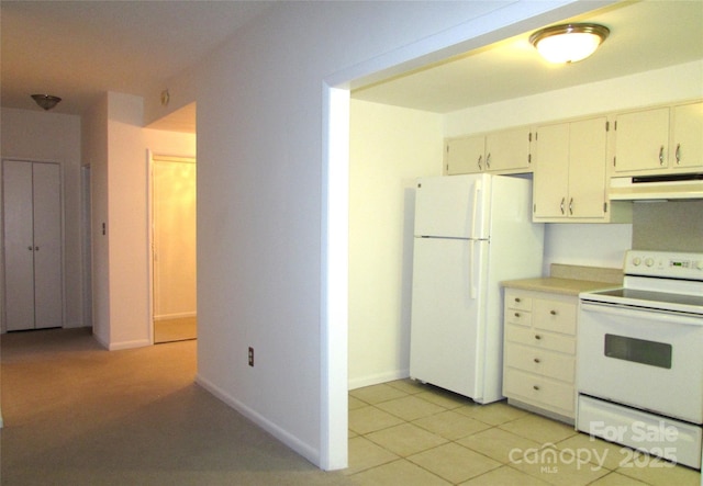 1300 Reece Rd Unit 302, Charlotte, NC 28209 - kitchen featuring white appliances, under cabinet range hood, light countertops, and light tile patterned floors