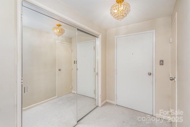 1300 Reece Rd Unit 302, Charlotte, NC 28209 - foyer entrance with light carpet and a chandelier