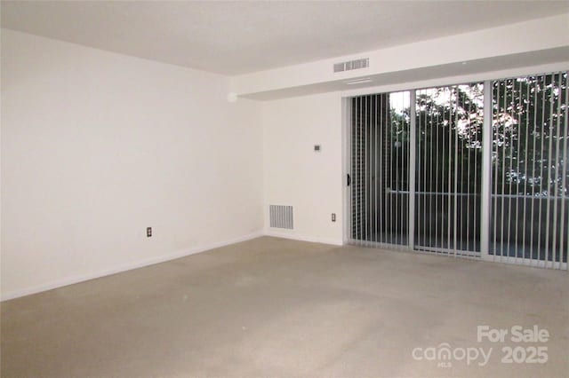 1300 Reece Rd Unit 302, Charlotte, NC 28209 - carpeted spare room featuring baseboards