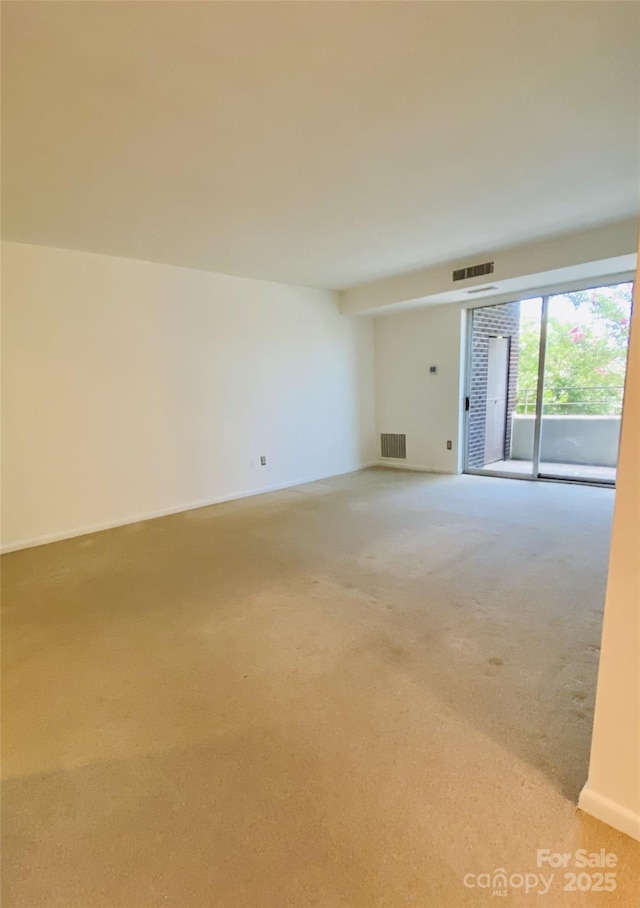 1300 Reece Rd Unit 302, Charlotte, NC 28209 - spare room featuring light colored carpet and baseboards