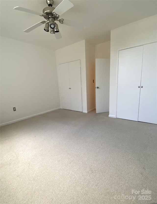 1300 Reece Rd Unit 302, Charlotte, NC 28209 - unfurnished bedroom featuring light colored carpet, ceiling fan, and two closets