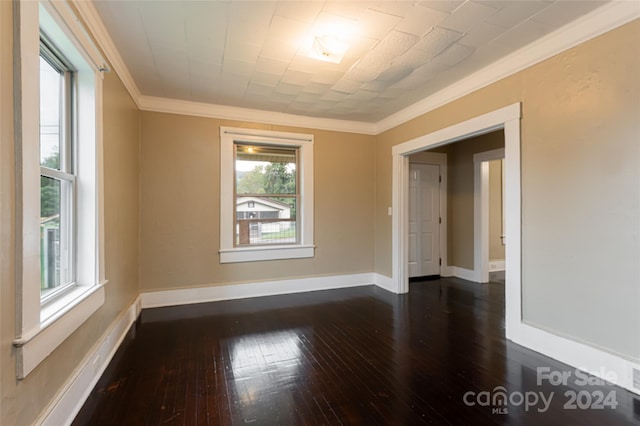 unfurnished room with ornamental molding and dark hardwood / wood-style flooring