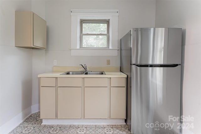 kitchen featuring sink, stainless steel fridge, and light tile patterned flooring