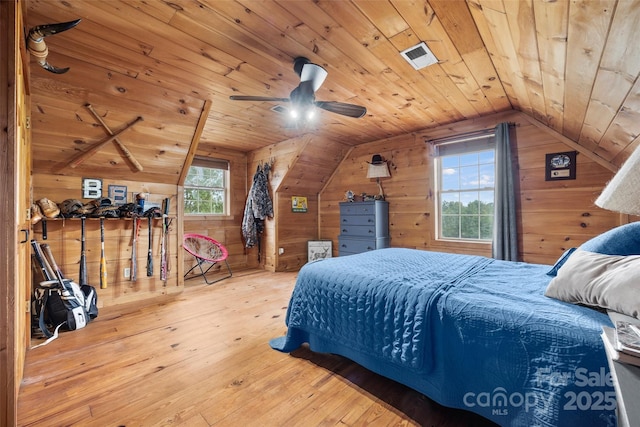 bedroom featuring hardwood / wood-style flooring, vaulted ceiling, wood ceiling, and wood walls