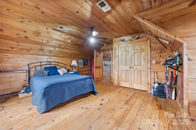 bedroom featuring hardwood / wood-style floors, lofted ceiling, wood walls, and wooden ceiling