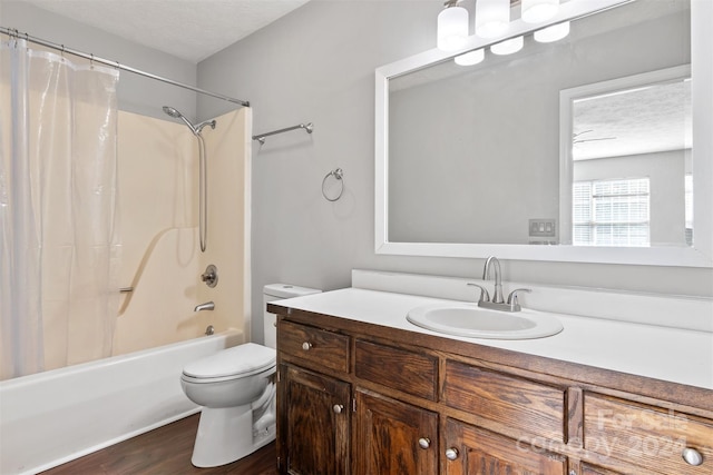 full bathroom with vanity, shower / bath combo, a textured ceiling, hardwood / wood-style flooring, and toilet