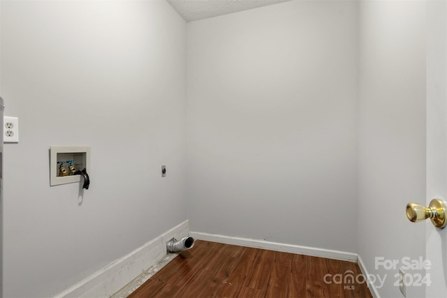 washroom with hookup for a washing machine, a textured ceiling, hardwood / wood-style floors, and electric dryer hookup