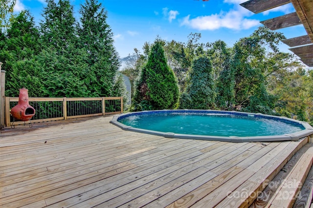 view of swimming pool featuring a deck