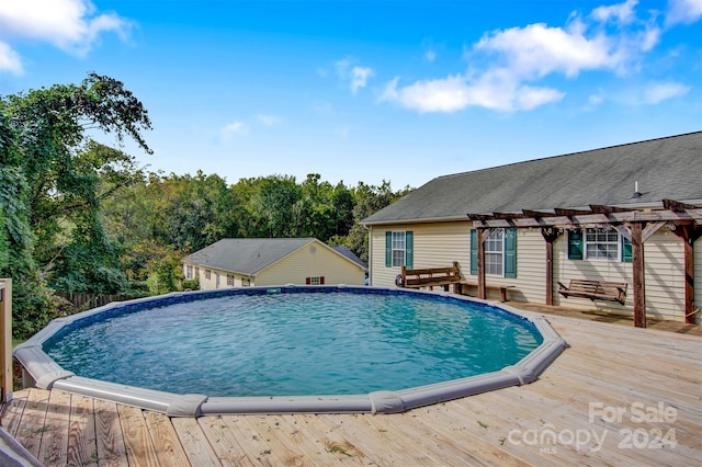 view of pool with a pergola and a deck