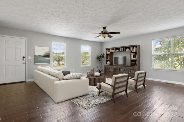 living room featuring a textured ceiling, dark hardwood / wood-style floors, and ceiling fan